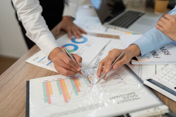 Financial Analysis. Close-up of hands reviewing budget charts and graphs at desk.