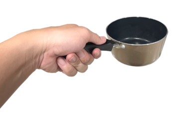 Hand holding the pot.