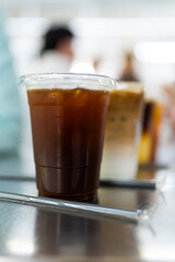 Ice americano coffee in a disposable glass in hot day