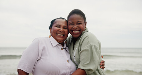 Portrait, mother and daughter with hug on beach for travel, sea holiday and getaway. African family, laughing and embrace with mature woman, ocean vacation and bonding together on trip in nature
