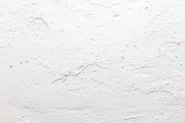 A white wall with a rough texture
