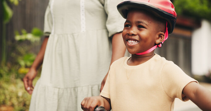 Support, learning and happy boy on bike with mom on street of neighborhood for child development. Smile, love or African kid with trust, help or single mother teaching son how to ride bicycle outside
