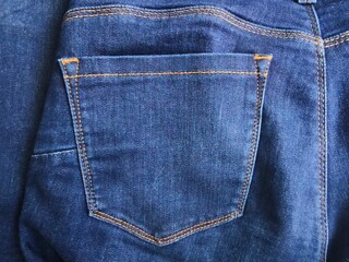 pocket and small pocket in faded blue jeans,