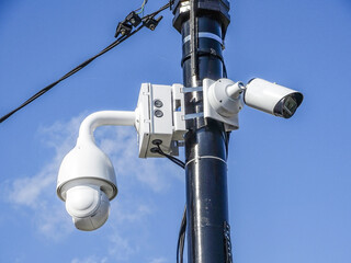 Video surveillance camera on a pole in the city