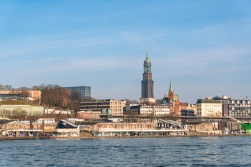 Fototapeta premium Landungsbrücken and St. Michaelis Church in Hamburg, Germany on a sunny day