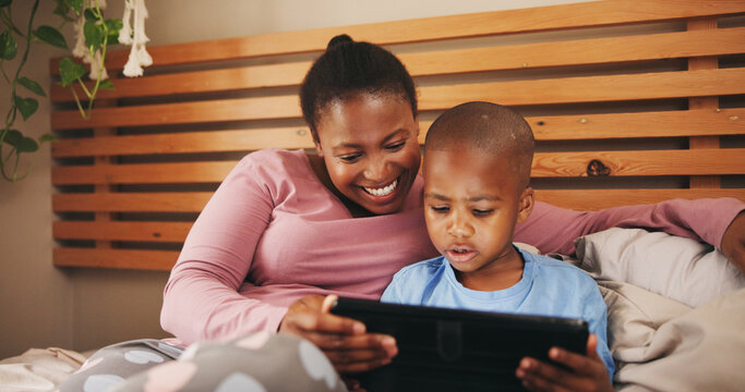 Relax, tablet and black mother with child in bed for bonding with watching movie, video or film. Happy, morning and African mom with kid on digital technology for streaming series together in home.