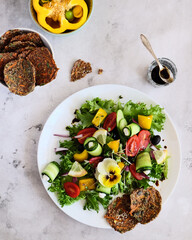 Experience a Vibrant Salad Made with Fresh Vegetables and Accompanied