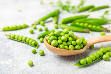 Fresh green pea pods with green peas on a wooden background. Sweet green peas. Green pea beans vegetables. Vegan. healthy vegetable. Copy space