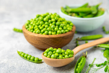 Fresh green pea pods with green peas on a wooden background. Sweet green peas. Green pea beans vegetables. Vegan. healthy vegetable. Copy space