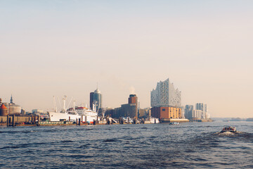 Fototapeta premium Cinematic Waterfront View of Hamburg with Elbphilharmonie at Sunset
