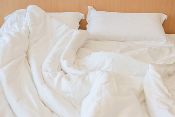 Messy bed in the hotel room