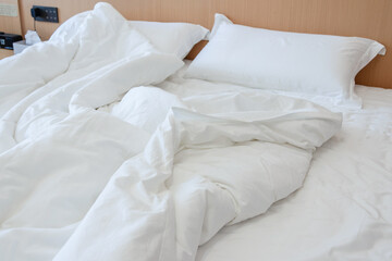 Messy bed in the hotel room