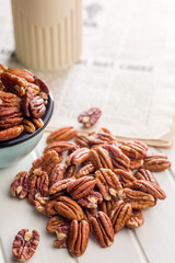 Peeled pecan nuts on white table.