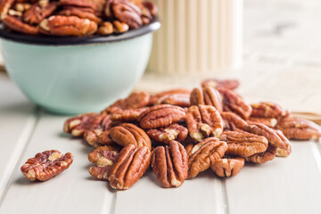 Peeled pecan nuts on white table.