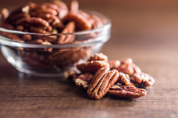 Peeled pecan nuts on wooden table.