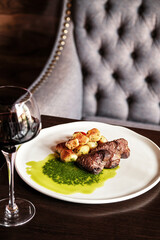 A Gourmet Plate featuring Steak accompanied by Sauce in a