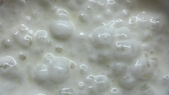 Closeup of bubbling fermentation process in action with active yeast culture