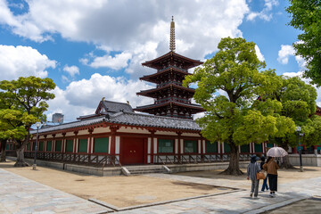 Women walking near pagoda at Shitenno-ji Temple in Osaka, Japan