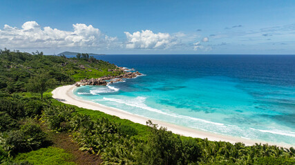 A secluded cove with calm turquoise waters and white sandy beach. Seychelles, La Digue. Anse Cocos.