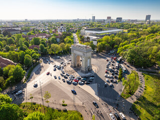 Arch of Triumph in Bucharest aerial photo. Travel to Bucharest Romania. Aerial view over this amazing historical landmark from Romania during a summer day with green parks landscape.