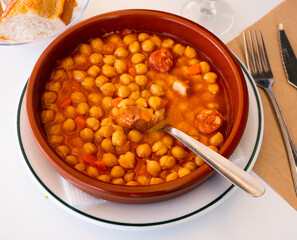 Spanish chickpeas stew with ham from Rioja served in a ceramic bowl in a restaurant