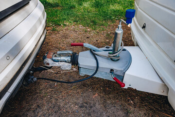 Hooking up caravan to a car. Сouple a trailer (i.s., hooked) into a ball-type tow hitch. Trailer coupling for caravans