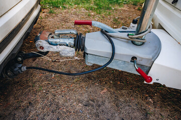Hooking up caravan to a car. Сouple a trailer (i.s., hooked) into a ball-type tow hitch. Trailer coupling for caravans