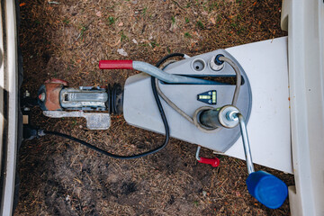 Hooking up caravan to a car. Сouple a trailer (i.s., hooked) into a ball-type tow hitch. Trailer coupling for caravans