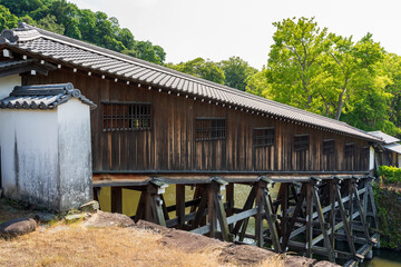 The historic Ohashi Roka, a unique sloping covered wooden corridor bridge over the moat at Wakayama Castle, Wakayama, Japan.