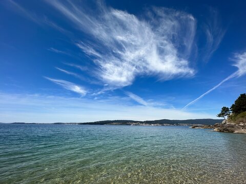Atlantic Ocean seascape with fluffy clouds and crystal clear water, Seixo, Mar&iacute;n, Galicia, Spain, April 2024