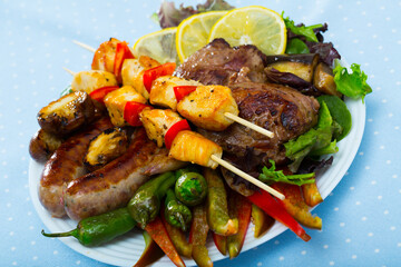 Plate of dish bulgarian cuisine meshana scara with different grilled meat and vegetables