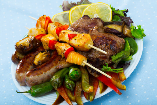 Plate of dish bulgarian cuisine meshana scara with different grilled meat and vegetables