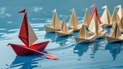 Red origami boat leading paper ships