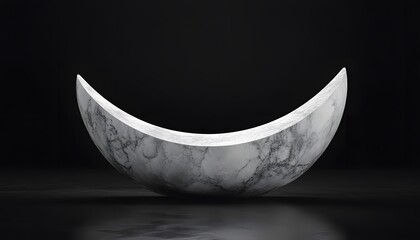 Crescent-shaped marble sculpture against a dark background.