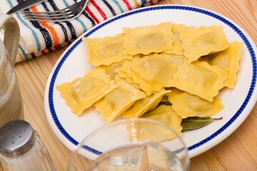 Delicious appetizing ravioli with bay leaf and black pepper. High quality photo