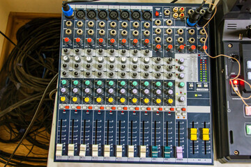 Multi-colored buttons, switches and sliders on the audio mixer panel