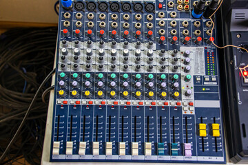 Multi-colored buttons and sliders on the audio mixer panel