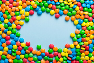 Mixed collection of colorful candy, on colored background. Flat lay, top view. frame of colorful...