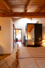 Interior of a double bedroom with two beds in a mountain hut.