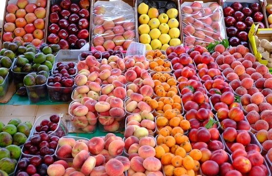 Vibrant display of assorted fresh fruits at market stall - Powered by Adobe