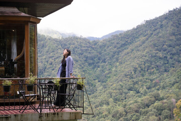 digital nomad concept asian freelancer woman relax and outdoor work at mountain view of coffeeshop