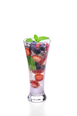 Refreshing summer drink with strawberries, blueberries, blackberries, mint and sparkling water in a tall glass. Healthy and natural beverage on white background.