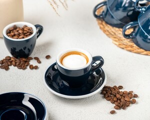 Freshly brewed coffee with beans and blue cups
