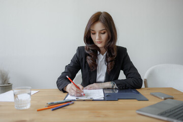 Professional woman working on a project at a modern office desk during the daytime