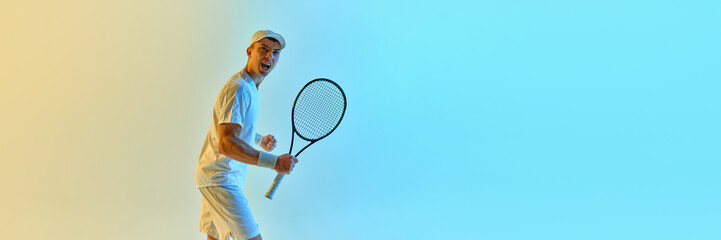 Banner. Triumphant moment as tennis player celebrates, racket in hand and fist raised against...