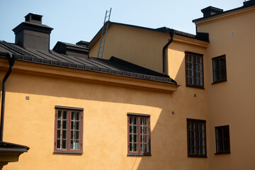 Typical Swedish building style with Nordic Classicism and Swedish Grace architecture style with yellow plaster walls on house on Skeppsholmen island