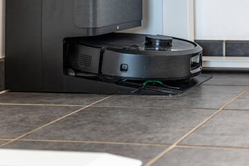 Robot vacuum cleaner with dust, real life photo, saves time and goes into hard-to-reach places