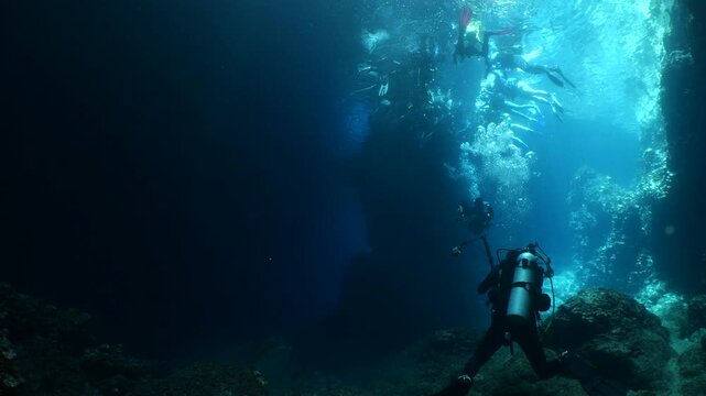 people are making a circle to make a pose for fotograph in an underwater cave