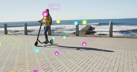 Woman scooting along seaside promenade activating swirling social media icons showing engagement - Powered by Adobe