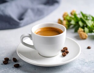 Obraz premium Espresso in white cup, with coffee beans and flowers